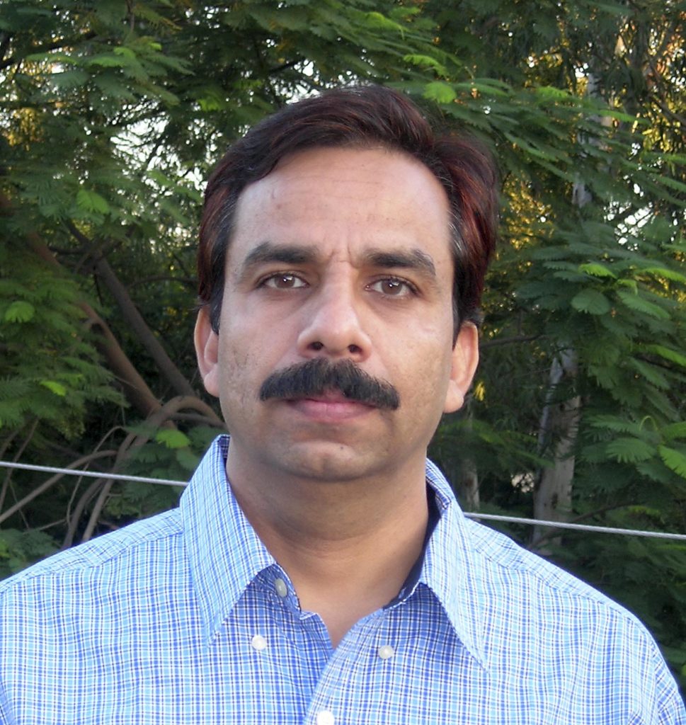 Photo of Dinesh Mohan in front of trees