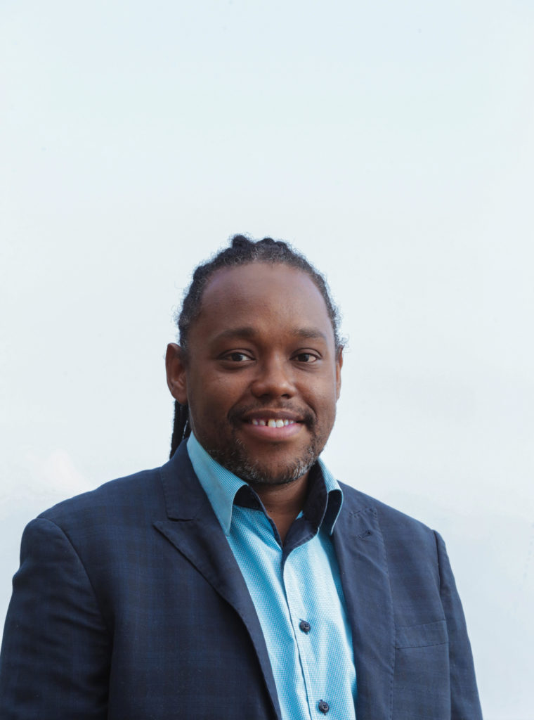 Photo of Michael Forde with pale blue background