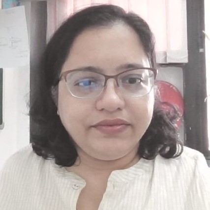 A photo of Annamma Anil Odaneth with an office window in the background.