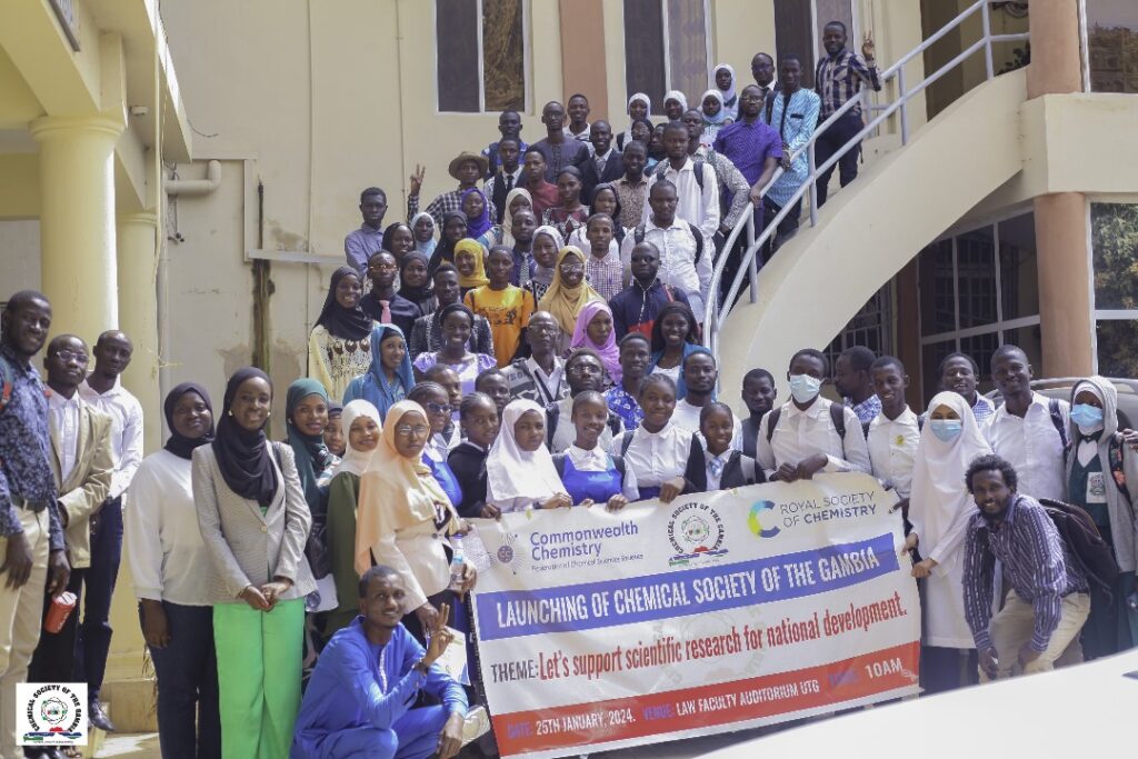 Students holding banner celebrating the launching of the chemical society of the Gambia